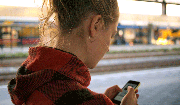 Woman looking at phone with poor posture