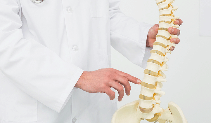 Atstock Productions/Bigstock.com doctor holding a model of a spine pointing to spinal discs in Clifton, New Jersey